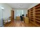 Office with wood floors, built-in bookshelves, a ceiling fan, and natural light at 19472 N Marble Canyon Ct, Surprise, AZ 85374