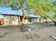 Large backyard featuring mature shade trees, desert landscaping, with an outdoor patio area, fire pit, and stone seating at 19604 N 13Th Ave, Phoenix, AZ 85027