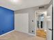 Bedroom featuring plush carpeting, a sizable closet, and a blue accent wall at 19604 N 13Th Ave, Phoenix, AZ 85027