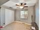 Cozy bedroom featuring a ceiling fan, a large window, and closet space at 19604 N 13Th Ave, Phoenix, AZ 85027