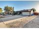 Traditional single-story house featuring a two-car garage, desert landscaping and driveway basketball court at 19604 N 13Th Ave, Phoenix, AZ 85027