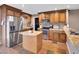 Open kitchen with stainless appliances, granite counters, and a center island at 19604 N 13Th Ave, Phoenix, AZ 85027