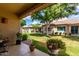 Charming covered patio with lush greenery and views of neighboring houses at 23813 S Pleasant Way, Sun Lakes, AZ 85248