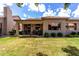Expansive backyard with covered patio, well-maintained lawn, and privacy landscaping at 23813 S Pleasant Way, Sun Lakes, AZ 85248