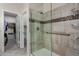 Bathroom featuring a glass enclosed walk-in shower with tiled walls and storage shelves at 23813 S Pleasant Way, Sun Lakes, AZ 85248