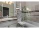 Well-lit bathroom featuring a granite vanity, a glass-enclosed shower, and tiled walls at 23813 S Pleasant Way, Sun Lakes, AZ 85248