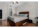 Well-lit bedroom with fan and light fixture, carpeted floors, a walk in shower through arched doorway at 23813 S Pleasant Way, Sun Lakes, AZ 85248