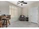 Bright bedroom with a ceiling fan, plantation shutters, and cozy seating area at 23813 S Pleasant Way, Sun Lakes, AZ 85248