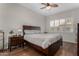 Comfortable bedroom featuring a ceiling fan and a large window for natural light and a bed with storage drawers at 23813 S Pleasant Way, Sun Lakes, AZ 85248