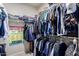 Walk-in closet featuring ample hanging space, shelving, and organized storage solutions for clothes and accessories at 23813 S Pleasant Way, Sun Lakes, AZ 85248