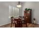 Bright dining area with a hardwood table and floors, complemented by natural light at 23813 S Pleasant Way, Sun Lakes, AZ 85248