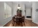 Cozy dining room with hardwood floors, shuttered windows, and decorative lighting at 23813 S Pleasant Way, Sun Lakes, AZ 85248