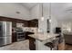 Contemporary kitchen with granite countertops, dark wood cabinets, and a kitchen island at 23813 S Pleasant Way, Sun Lakes, AZ 85248