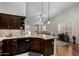 Modern kitchen seamlessly connected to the living space with counter seating at 23813 S Pleasant Way, Sun Lakes, AZ 85248