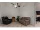 Cozy living room featuring tile flooring, neutral paint, ceiling fan and comfortable seating at 23813 S Pleasant Way, Sun Lakes, AZ 85248