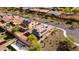 Stunning aerial view of a desert home, showcasing its tiled roof, solar panels, and a private pool in the backyard at 25540 N 103Rd Dr, Peoria, AZ 85383