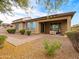 Backyard featuring a covered patio area and low-maintenance gravel landscaping at 25540 N 103Rd Dr, Peoria, AZ 85383