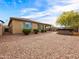 Backyard view with a spa, covered patio, gravel landscaping, and a view of the home's exterior at 25540 N 103Rd Dr, Peoria, AZ 85383