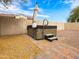 Backyard with a private spa surrounded by gravel landscaping and a block wall at 25540 N 103Rd Dr, Peoria, AZ 85383