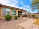 Covered patio and hardscape provide a relaxing outdoor living space in this backyard at 25540 N 103Rd Dr, Peoria, AZ 85383
