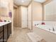 Bathroom view with a soaking tub, double vanity, and neutral color scheme at 25540 N 103Rd Dr, Peoria, AZ 85383