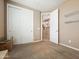 Neutral bedroom featuring sliding closet doors, carpet flooring, and an open door to the next room at 25540 N 103Rd Dr, Peoria, AZ 85383
