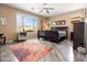 Serene bedroom showcasing a large window, wood flooring, ceiling fan, and tasteful décor at 25540 N 103Rd Dr, Peoria, AZ 85383