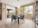 Bright dining area featuring neutral tones, elegant chandelier, and views of the outdoor patio and lush backyard at 25540 N 103Rd Dr, Peoria, AZ 85383