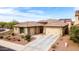Stunning home with a two-car garage, beautiful landscape, and a well-manicured lawn under a sunny blue sky at 25540 N 103Rd Dr, Peoria, AZ 85383