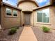 Welcoming home entrance with a charming walkway and well-kept desert landscaping at 25540 N 103Rd Dr, Peoria, AZ 85383