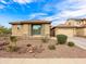 Inviting single-story house featuring desert landscaping, stone accents, and a tidy facade on a sunny day at 25540 N 103Rd Dr, Peoria, AZ 85383