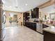 Spacious kitchen showcasing dark wood cabinets, granite countertops, stainless steel appliances, and a breakfast bar at 25540 N 103Rd Dr, Peoria, AZ 85383