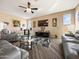 Relaxing living room boasting a TV set, modern seats, hardwood floor, and large windows, ideal for entertainment at 25540 N 103Rd Dr, Peoria, AZ 85383