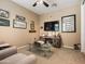 Relaxing living room featuring neutral carpet, a fan, and a glass coffee table at 25540 N 103Rd Dr, Peoria, AZ 85383