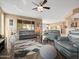 Open-concept living room boasts hardwood floors, comfortable seating, and ample natural light, perfect for relaxation at 25540 N 103Rd Dr, Peoria, AZ 85383