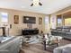 Spacious living room features wood flooring, modern furnishings, and bright windows for a welcoming atmosphere at 25540 N 103Rd Dr, Peoria, AZ 85383