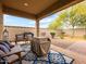 Covered patio with seating, a decorative rug, and a view of the landscaped backyard at 25540 N 103Rd Dr, Peoria, AZ 85383