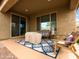 Covered patio with a seating area, outdoor decor, and access to the home's interior at 25540 N 103Rd Dr, Peoria, AZ 85383