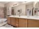 Bathroom featuring double sinks with a large mirror, tile floors, a tub, and vanity lighting at 25845 N 44Th Ave, Phoenix, AZ 85083