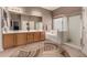 Serene bathroom features a double sink vanity, soaking tub, and a glass-enclosed shower for a spa-like experience at 25845 N 44Th Ave, Phoenix, AZ 85083