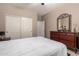 Comfortable bedroom featuring a wrought iron bed, neutral walls, and a practical closet for an organized living space at 25845 N 44Th Ave, Phoenix, AZ 85083