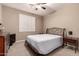 Cozy bedroom with a classic iron bed frame, a comfortable neutral carpet and soft natural light from the window at 25845 N 44Th Ave, Phoenix, AZ 85083