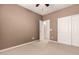 Neutral bedroom featuring carpet, baseboards, ceiling fan and a closet for storage at 25845 N 44Th Ave, Phoenix, AZ 85083