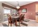 Open dining area with wooden chairs and table with a sliding glass door leading to the patio at 25845 N 44Th Ave, Phoenix, AZ 85083