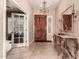 Entryway featuring a dark wood front door, chandelier, and a mirrored table at 25845 N 44Th Ave, Phoenix, AZ 85083