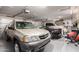 Spacious three car garage with multiple vehicles and ample storage space at 25845 N 44Th Ave, Phoenix, AZ 85083