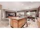 Spacious kitchen seamlessly flows into the dining and living areas, featuring an island with sink and stainless dishwasher at 25845 N 44Th Ave, Phoenix, AZ 85083