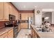 Bright kitchen featuring stainless steel appliances, ample wood cabinetry, and a convenient center island with double sink at 25845 N 44Th Ave, Phoenix, AZ 85083