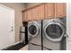 Laundry room featuring cabinets, side by side washer and dryer, and black rug at 25845 N 44Th Ave, Phoenix, AZ 85083