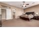 Expansive main bedroom with neutral tones, ensuite bathroom entrance and ample space for relaxation and personalization at 25845 N 44Th Ave, Phoenix, AZ 85083